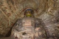 Looking up at a Buddha statue in cave 6 of the Yungang Grottoes Royalty Free Stock Photo