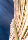 Long exposure photograph looking up at building with long exposure of clouds