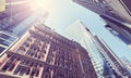 Looking up at buildings in New York City against the sun, color toned picture, USA Royalty Free Stock Photo