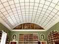 Looking up at the ceiling and classical paintings in the Regency library at Stourhead House in Wiltshire