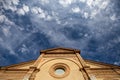 Looking up at a church with sky