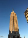 Looking up at the Empire State Building at the golden hour, warm light illuminates the iconic Art Deco skyscraper in midtown Royalty Free Stock Photo