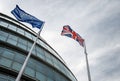 Looking up at EU and UK flags outside City Hall, London Royalty Free Stock Photo