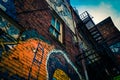 Looking up at graffiti and old staircases in Graffiti Alley, Baltimore, Maryland.