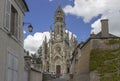 Looking up a hill at a unique pale stone church