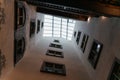 Looking up into a historic interior courtyard with tall walls, classic windows, and a glass skylight creating a dramatic Royalty Free Stock Photo