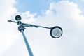 Looking up at light post with blue sky and cloud