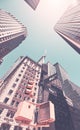 Looking up at Manhattan buildings at Wall Street against the sun, color toning applied, New York City, USA Royalty Free Stock Photo