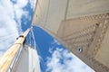 Looking up the mast on a sailing yacht; focussed on an eyelet in the sail Royalty Free Stock Photo