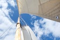 Looking up the mast on a sailing yacht, focussed on the flag at the masthead Royalty Free Stock Photo