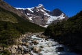 Looking up a meltwater stream towards the hanging glaciers that surround the w walk trail in Torres del Paine National Park Royalty Free Stock Photo