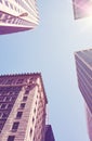 Looking up at New York buildings against the sun, color toned picture, USA Royalty Free Stock Photo