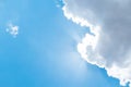 Looking up at Nice blue sky with sun beam behind big cloud Royalty Free Stock Photo