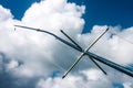 Looking up at ocean sport fishing outriggers against deep blue sky with clouds