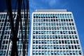 Looking up at office building in London with reflections and a flag