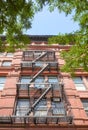 Looking up at an old red brick building with fire escape, New York City, USA Royalty Free Stock Photo