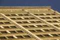 Looking up at older architectural brick and stone office building, symmetrical and modular