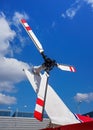 Looking up red and white rear helicopter rotor, sky with clouds background Royalty Free Stock Photo