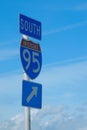 looking up at signage for Interstate 95 South, which is the main highway for the East Coast of the United States.