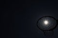 Looking up through silhouetted basketball goal to the moon at ni Royalty Free Stock Photo