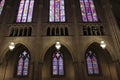 Looking up at six stained glass window on the side of the dimly lit Duke University Chapel\'s interior Royalty Free Stock Photo