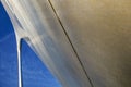 Looking up at the Gateway Arch, St Louis, close up exaggerated curving leg and blue sky