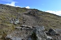 Looking up steep rough path with cairn