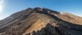 Looking up at the summit of Mount ruapehu in summer with light snow