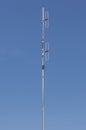 Looking up the telecommunication dipole antenna with blue sky ba