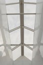 Looking up to the blue cloudy sky through modern square ceiling window. Royalty Free Stock Photo