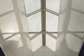 Looking up to the blue cloudy sky through modern square ceiling window. Royalty Free Stock Photo