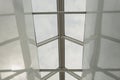 Looking up to the blue cloudy sky through modern square ceiling window. Royalty Free Stock Photo