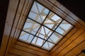 Looking up to the blue cloudy sky through modern square ceiling window. Royalty Free Stock Photo