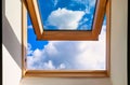 Looking up to the blue cloudy sky through modern square window Royalty Free Stock Photo