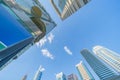 Looking up to high-rise office buildings, skyscrapers, architectures in financial district with blue sky. Smart urban city for Royalty Free Stock Photo