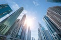 Looking up to high-rise office buildings, skyscrapers, architectures in financial district with blue sky. Smart urban city for Royalty Free Stock Photo