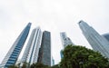 Looking up to high-rise office buildings, skyscrapers, architectures in financial district. Smart urban city for business and Royalty Free Stock Photo