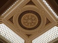 Looking up to an highly ornamental geometric glass window roof of a hall