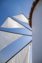 Greek Windmill sails against azure blue sky