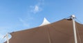 Looking up at the top of white tent against clear blue sky backg Royalty Free Stock Photo