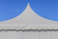 Looking up at the top of white tent with blue sky background Royalty Free Stock Photo