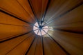 Looking up towards teepee-ceiling from inside the tent shows bright day light filtering in creating a cozy ambience Royalty Free Stock Photo