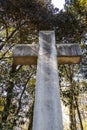 Looking up at a very large stone Christian cross