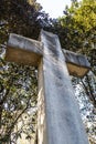 Looking up at a very large stone Christian cross