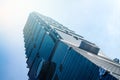 Looking up view of Taipei 101, the landmark of Taiwan, reflect blue sky and sun lights