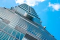 Looking up view of Taipei 101, the landmark of Taiwan, reflect blue sky and sun lights