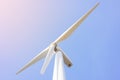 Looking up view of windmill or wind turbine under blue sky in the morning shows concept of renewable energy to supply and produce Royalty Free Stock Photo