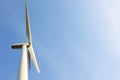 Looking up view of windmill or wind turbine under blue sky in the morning shows concept of renewable energy to supply and produce Royalty Free Stock Photo