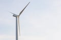 Looking up view of windmill or wind turbine under blue sky in the morning shows concept of renewable energy to supply and produce Royalty Free Stock Photo