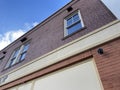 Looking up vintage brick facade windows and blue sky